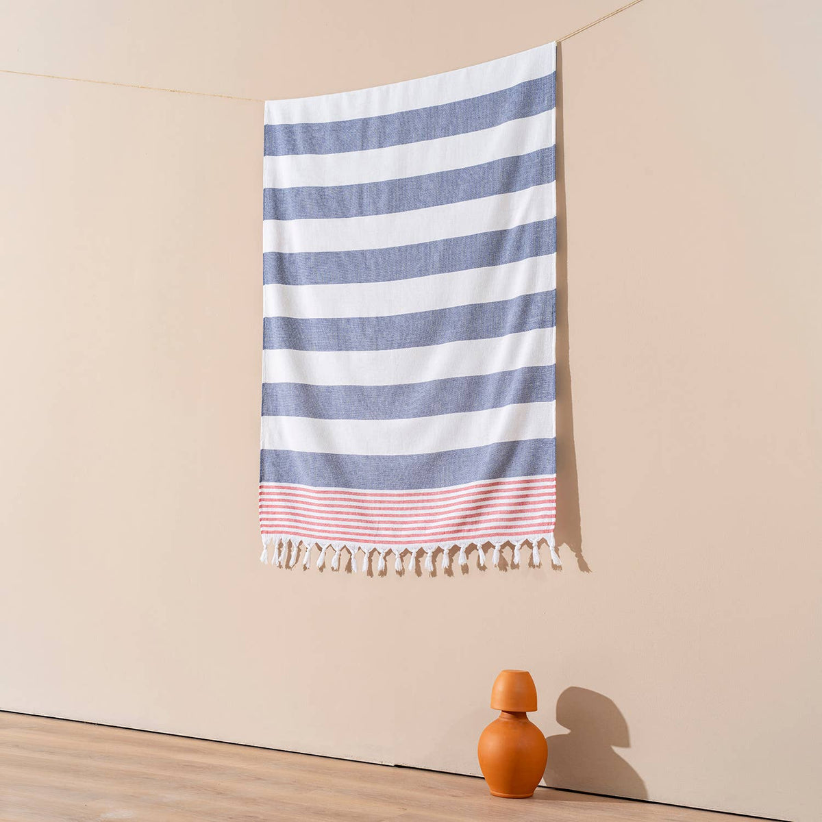 Navy and white block stripe terry-backed Turkish towel with red tassels | Kikoya