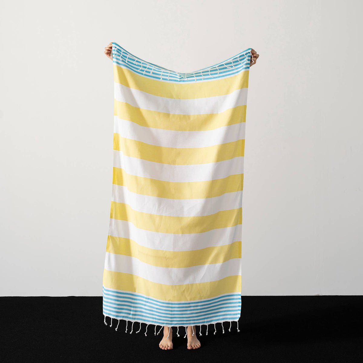 Yellow and turquoise cabana stripe beach towel folded | Kikoya