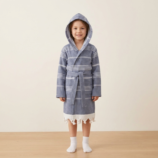 Child wearing the navy stripe Turkish hooded bathrobe with tasselled hem, ages 5-8 | Kikoya