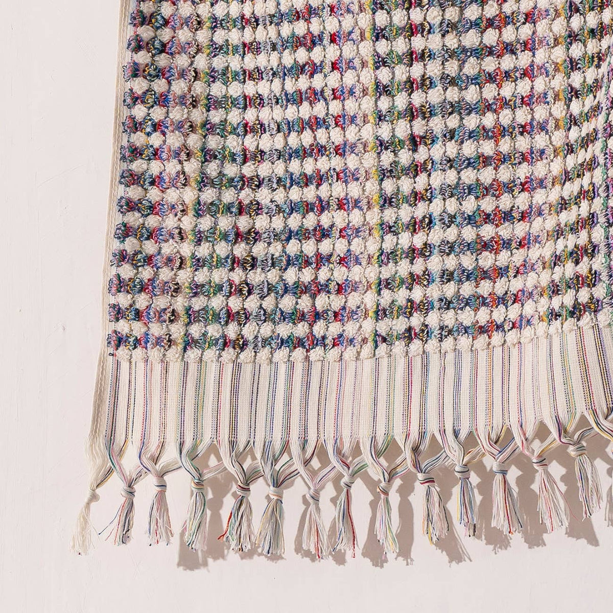Handloomed Turkish hand towel with multicolour pompoms, 17x38 in | Kikoya
