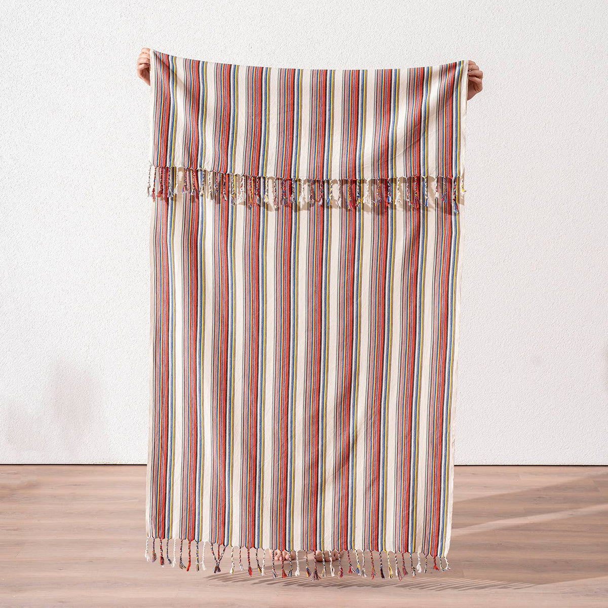 Bazaar stripe Turkish peshtemal in terracotta, mustard and blue on cream, held open | Kikoya