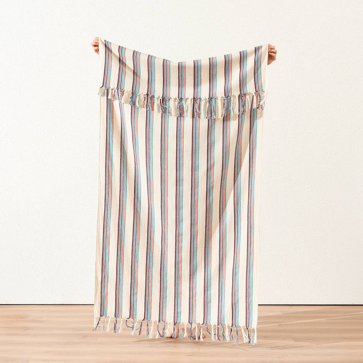 Teal and plum pinstripe Turkish peshtemal on cream, held open, 40x70 in | Kikoya