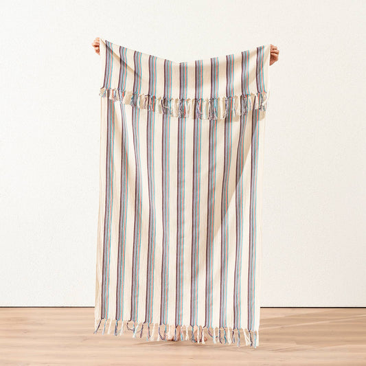 Teal and plum pinstripe Turkish peshtemal on cream, held open, 40x70 in | Kikoya
