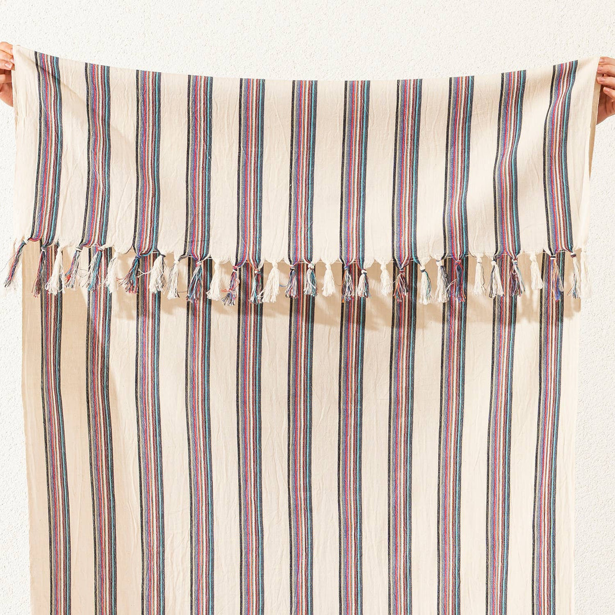 Hand-knotted fringe detail on the rose and navy pinstripe Turkish towel | Kikoya