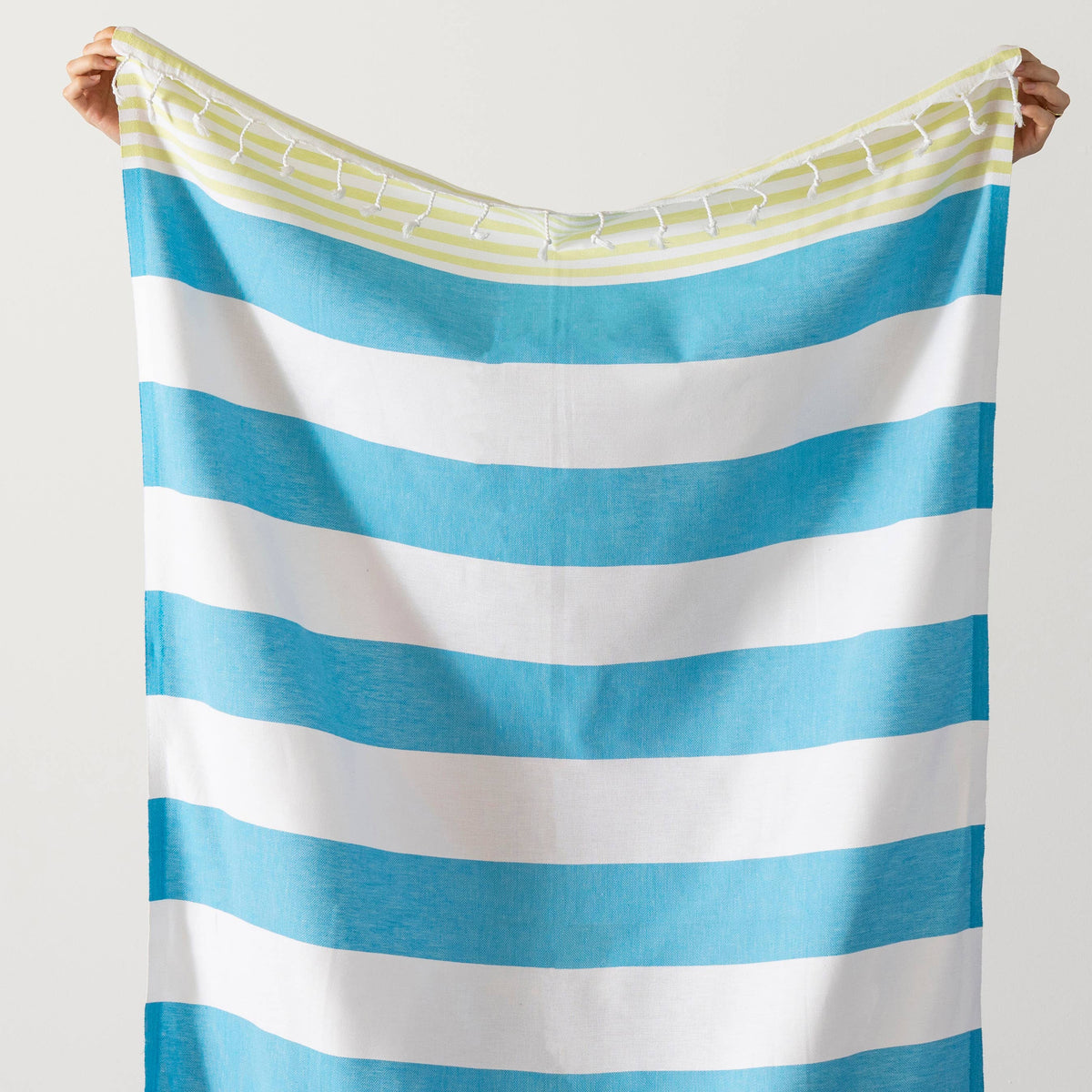 Turquoise and lime cabana stripe beach towel folded | Kikoya