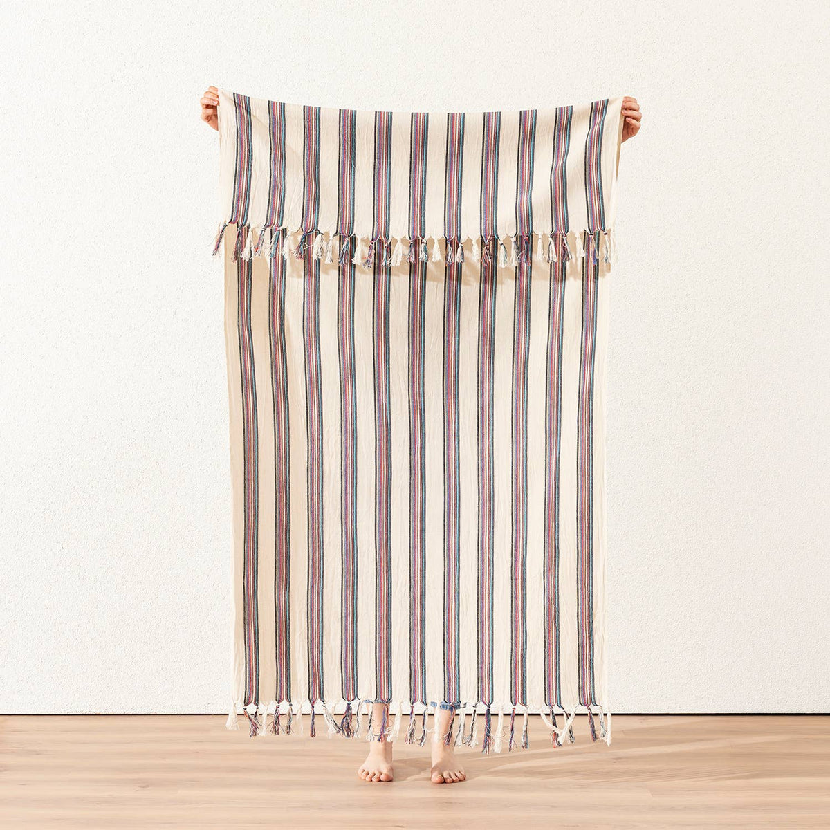 Rose and navy pinstripe Turkish peshtemal on cream, held open, 40x70 in | Kikoya