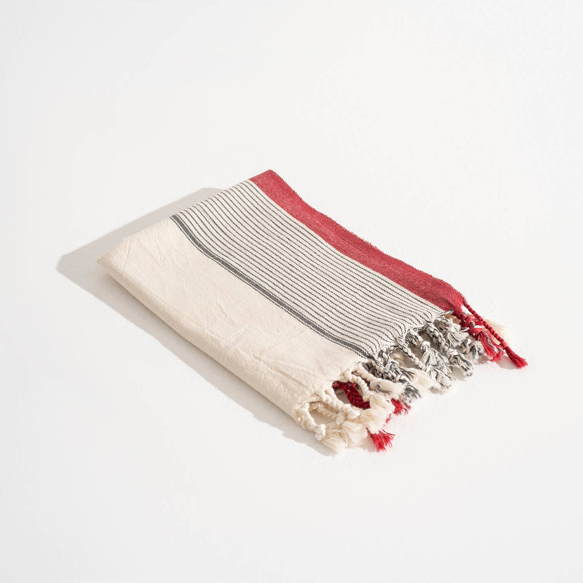 Burgundy Border Stripe peshtemal, folded with fringe | Kikoya
