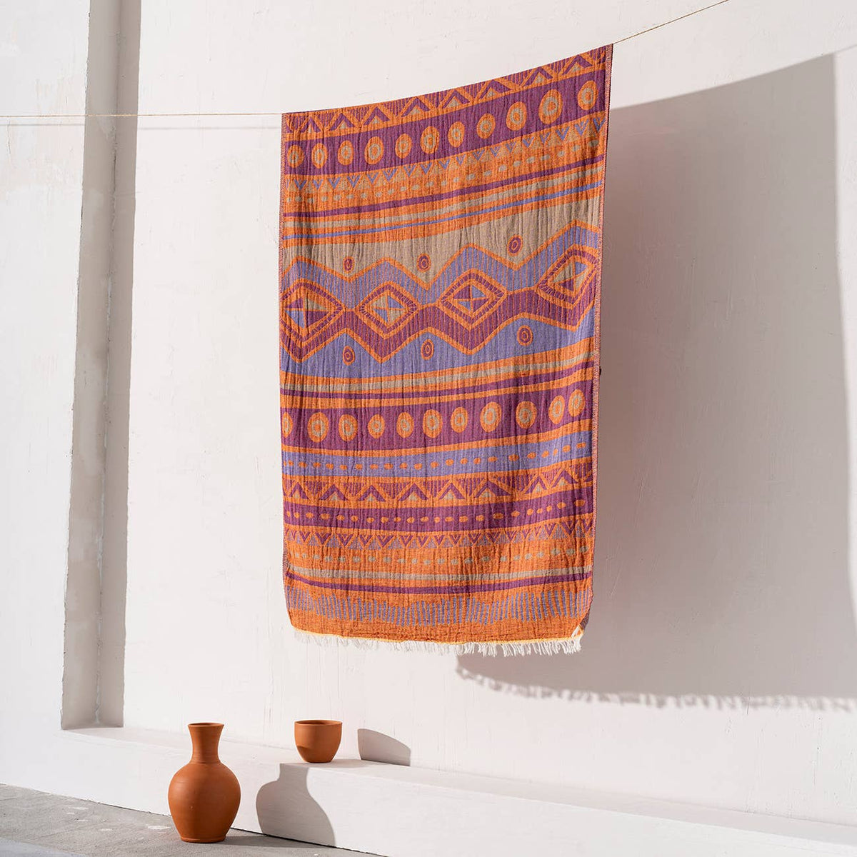 Ethnic jacquard Turkish beach towel in orange and purple, flat-woven | Kikoya
