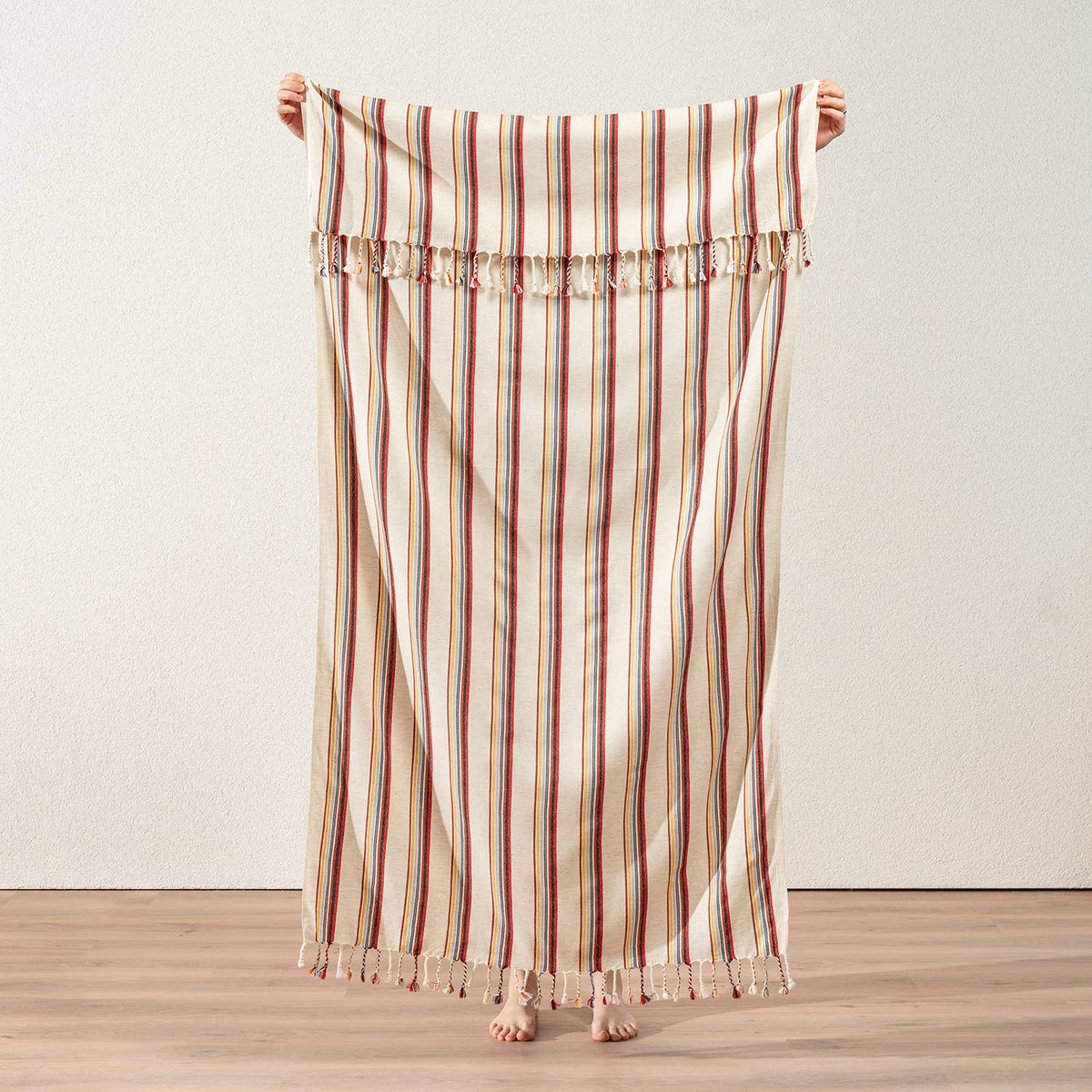 Linen-look Turkish peshtemal in multicolour pinstripes on cream, held open | Kikoya