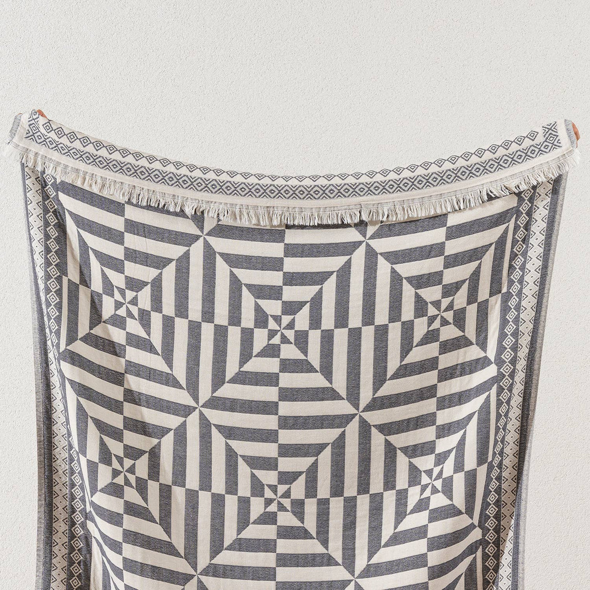 Geo Turkish cotton throw blanket – optic pinwheel, styled view | Kikoya