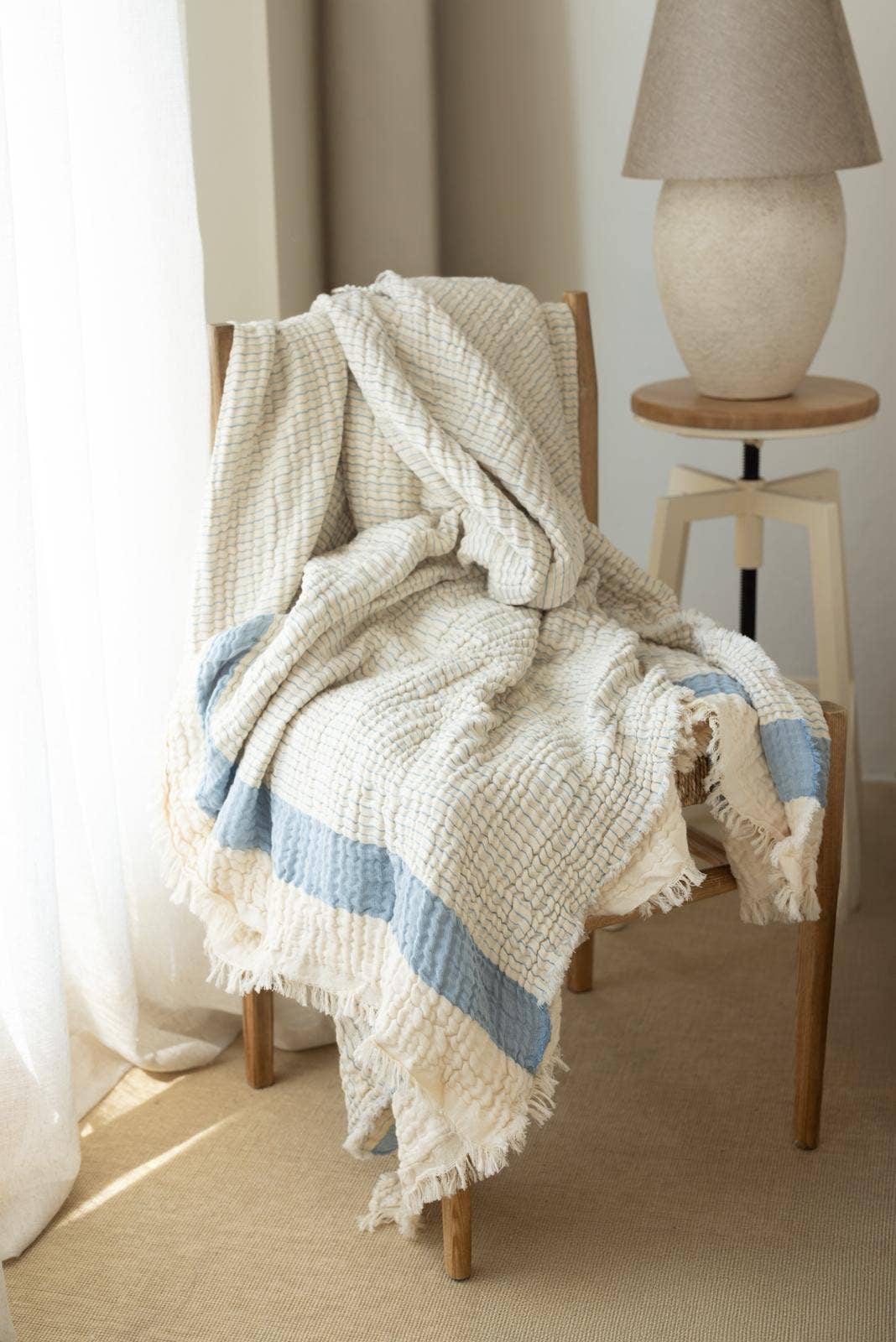 Modal muslin Turkish throw – 4-layer gauze, Blue, draped over a chair | Kikoya