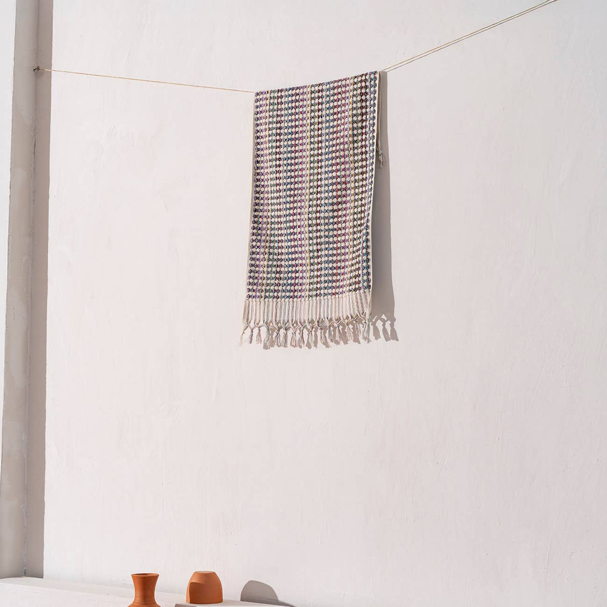 Handloomed Turkish hand towel with multicolour pompoms, 17x38 in | Kikoya