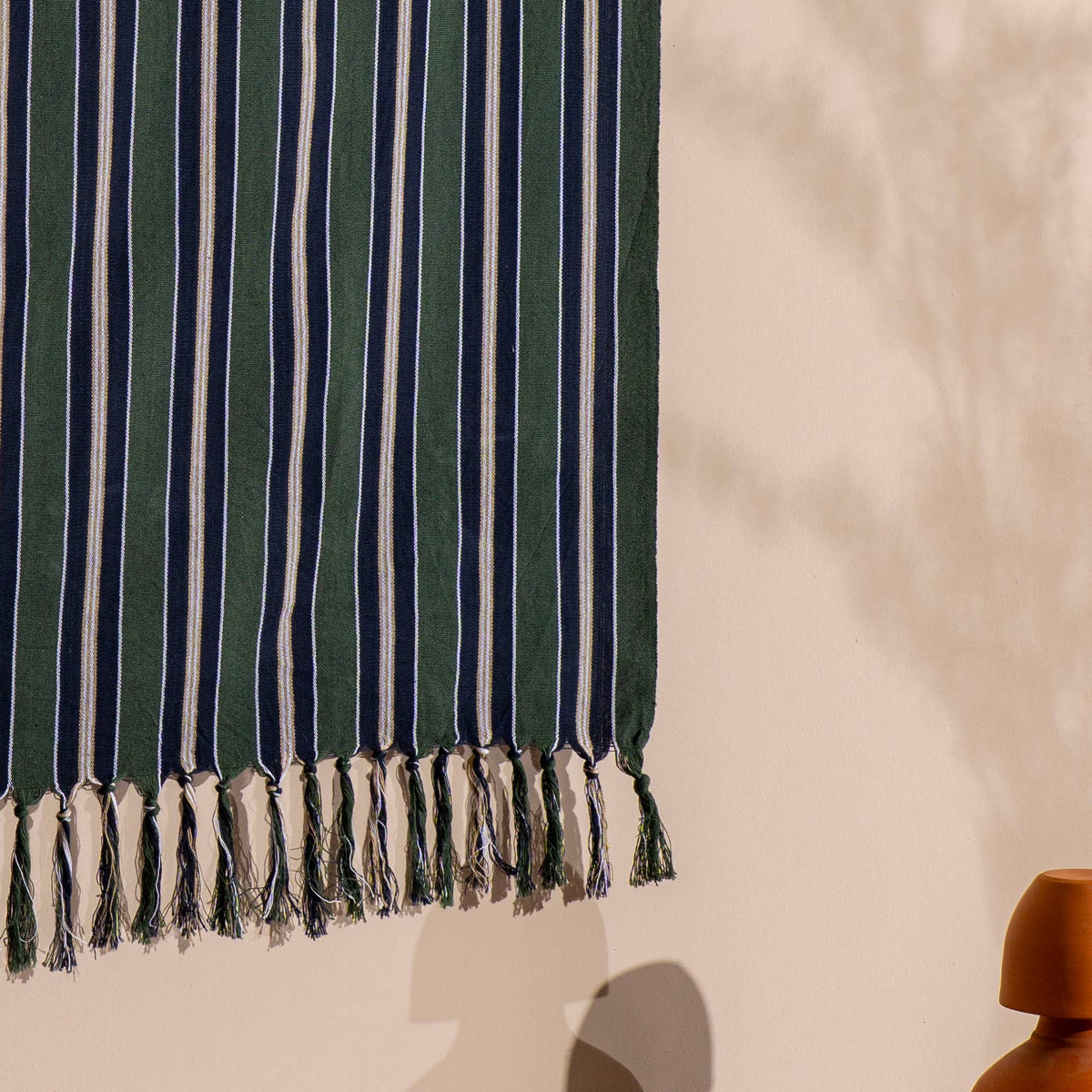 Forest green pinstripe Turkish peshtemal draped, showing hand-knotted fringe | Kikoya