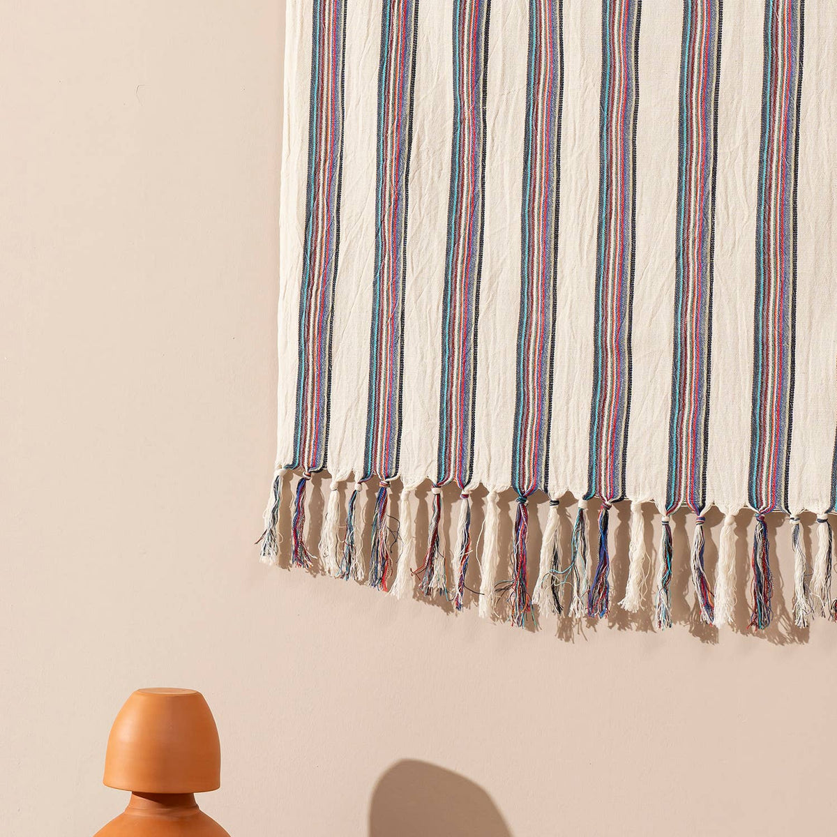 Fringed hem of the rose and navy pinstripe Turkish peshtemal | Kikoya