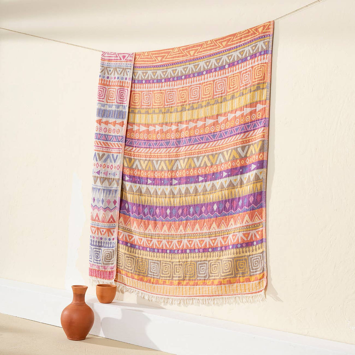 Ethnic Turkish cotton throw blanket – tribal stripe, Pink & Purple, styled on a wall | Kikoya