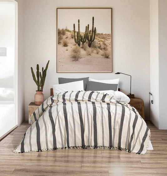 Wide stripe Turkish cotton bedspread – black on cream, styled on a bed | Kikoya