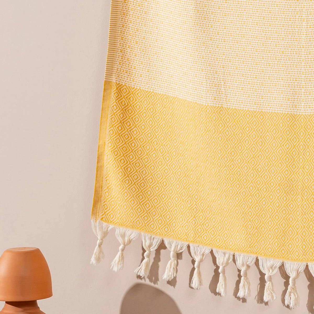 Yellow Topkapi Turkish towel draped to show the diamond weave and hand-knotted tassels | Kikoya